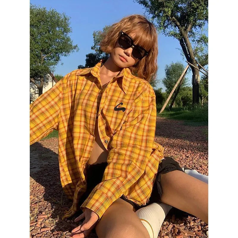 Dopamine yellow plaid shirt with loose cardigan fit on a hanger.