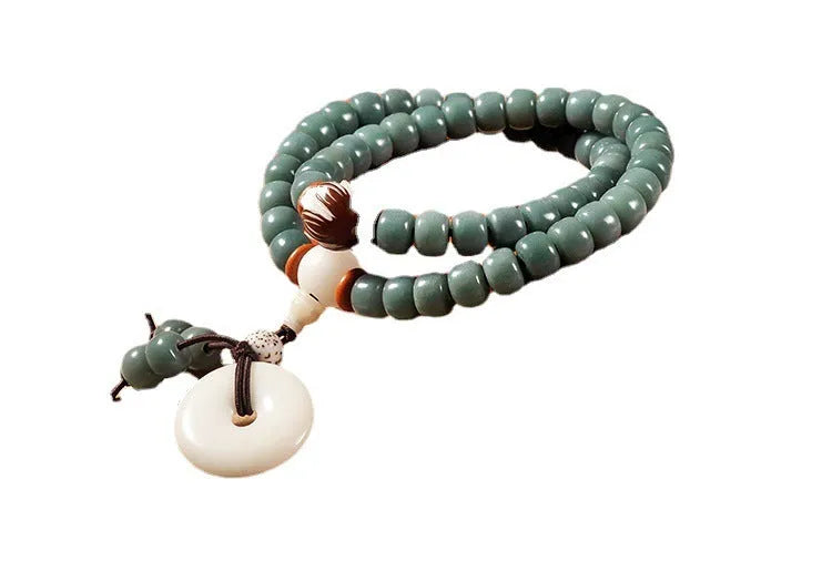 White jade Bodhi green sandalwood bracelet with beaded design and double ring safety buckle clasp.