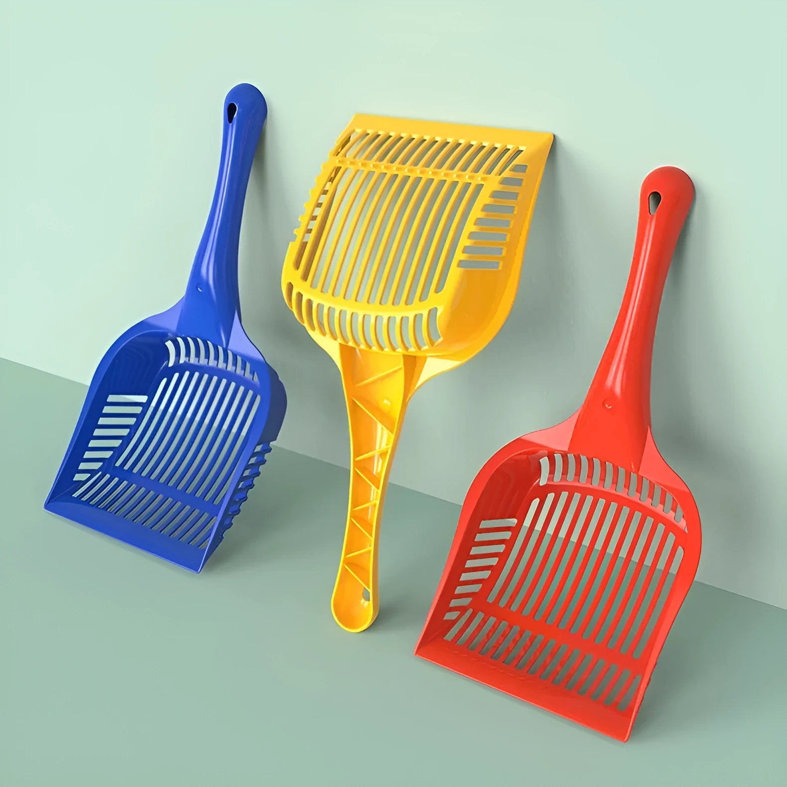 Plastic cat litter scoop in red, yellow and blue colours showing small and medium size options