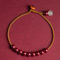 Hand-woven geometric bracelet made from raw red cinnabar ore on an adjustable cord.