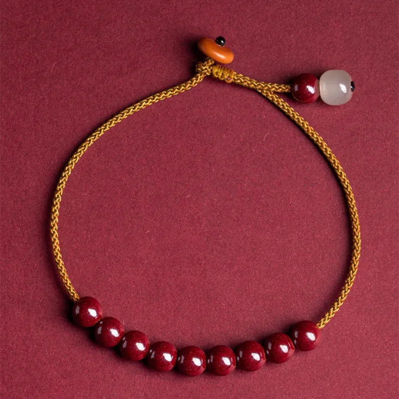 Hand-woven geometric bracelet made from raw red cinnabar ore on an adjustable cord.