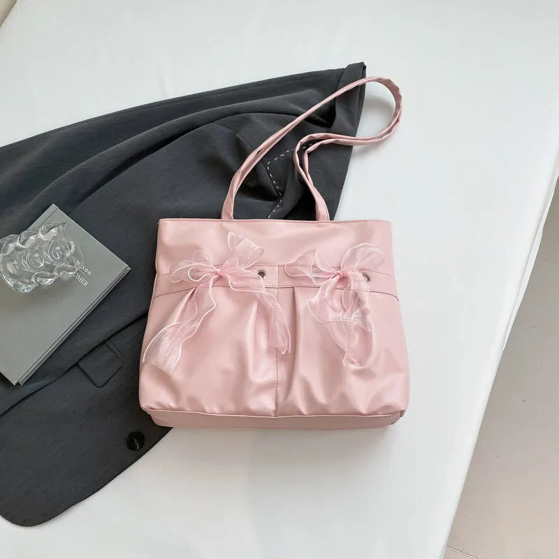 College style bow tote bag in black or pink with double shoulder straps and zippered compartment