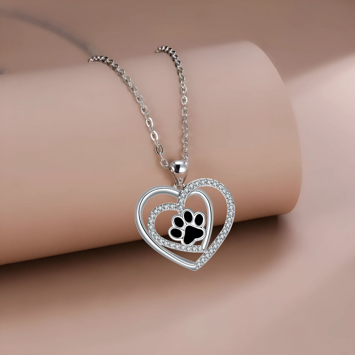 Women's necklace with a copper heart-shaped dog's paw pendant on a cross chain