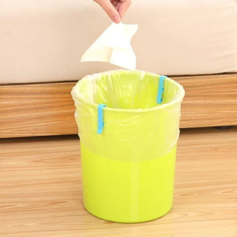 White PP plastic garbage bag fixing clip shown holding a black bin liner to the rim of a silver trash can.