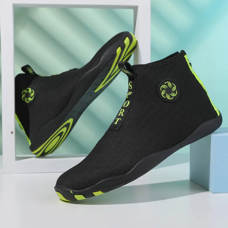 Men's black and fluorescent green quick-dry mesh beach shoes with a non-slip rubber sole on a rocky surface.