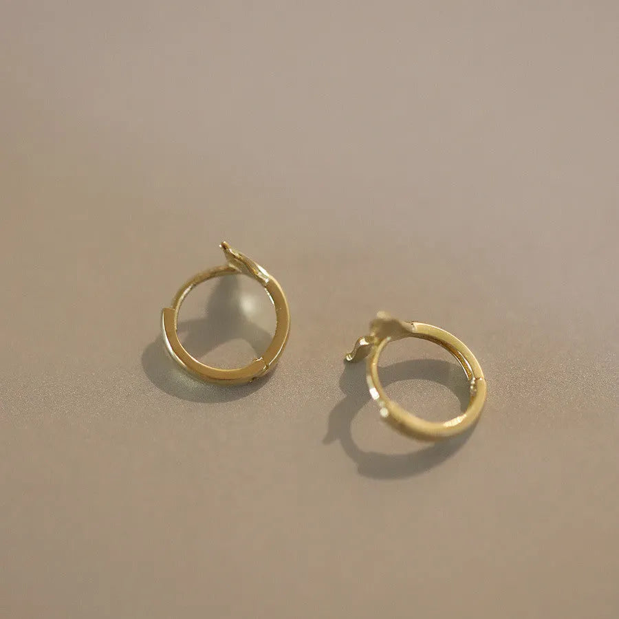 Gold plated sterling silver fish tail earrings for women, showing simple design and smooth finish.