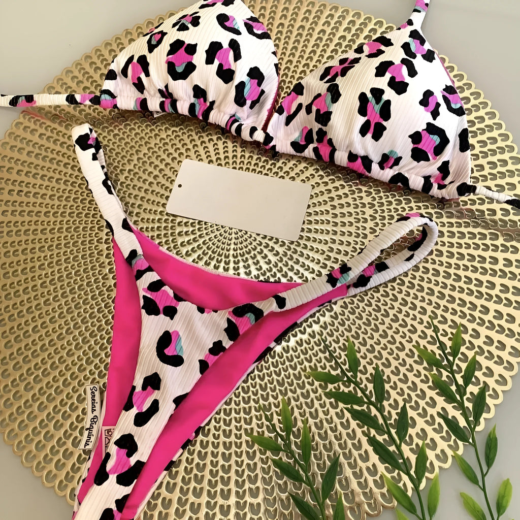 Women's printed bikini swimsuit set on a hanger, showing quick-dry fabric and cotton-lined briefs.