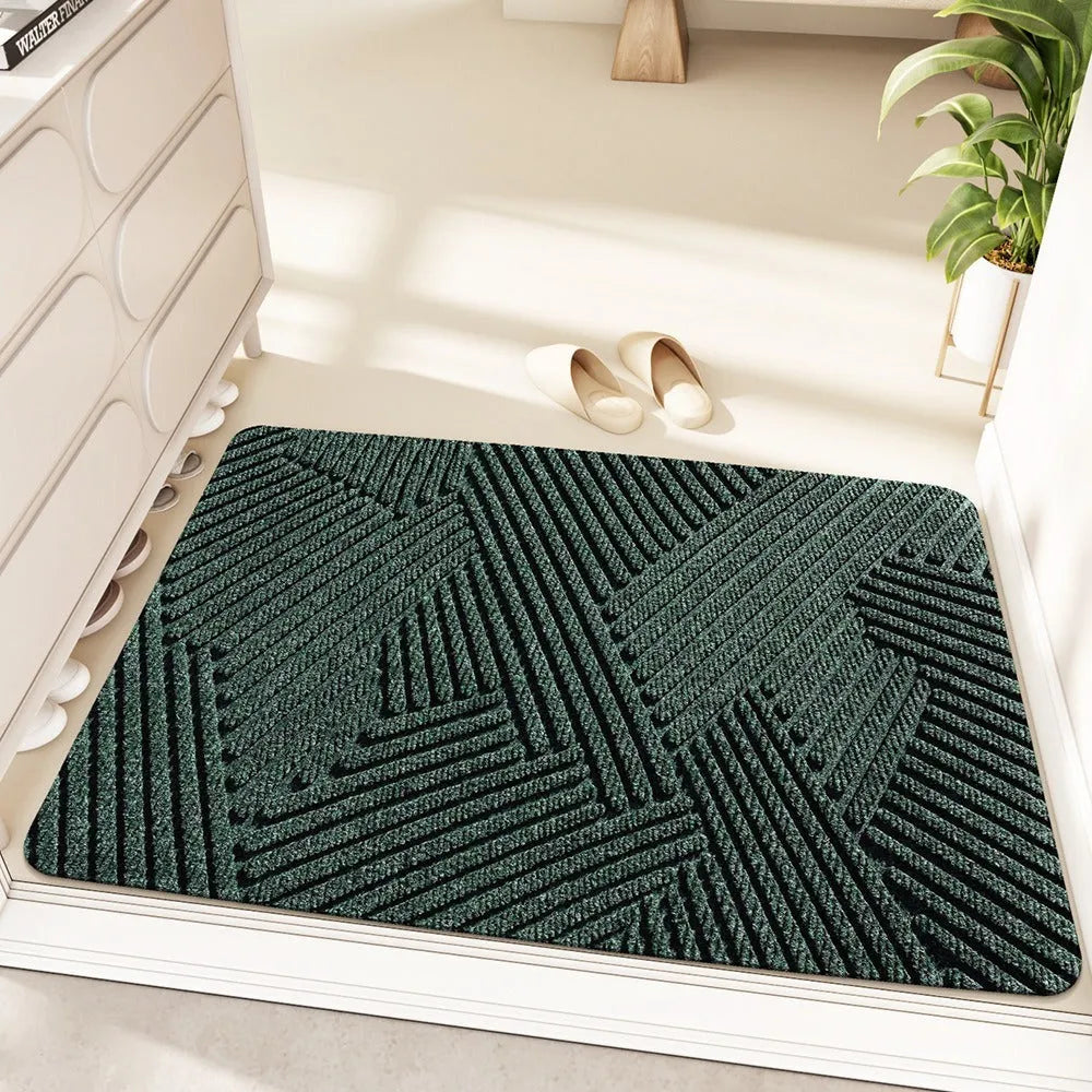Green diatom earth entrance floor mat with alien shape, wire ring border, and cartoon anime pattern.