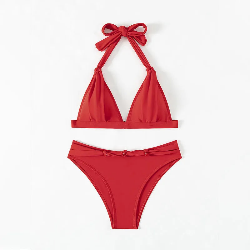 Red women's lace-up halterneck bikini set with split-bottom shorts on mannequin