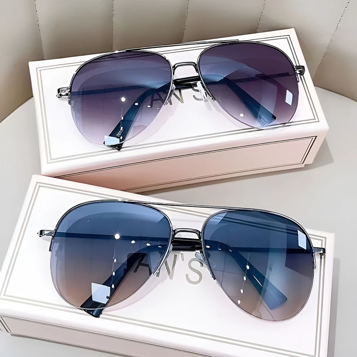 Gold frame aviator-style metal driving sunglasses with resin lenses for UV protection.