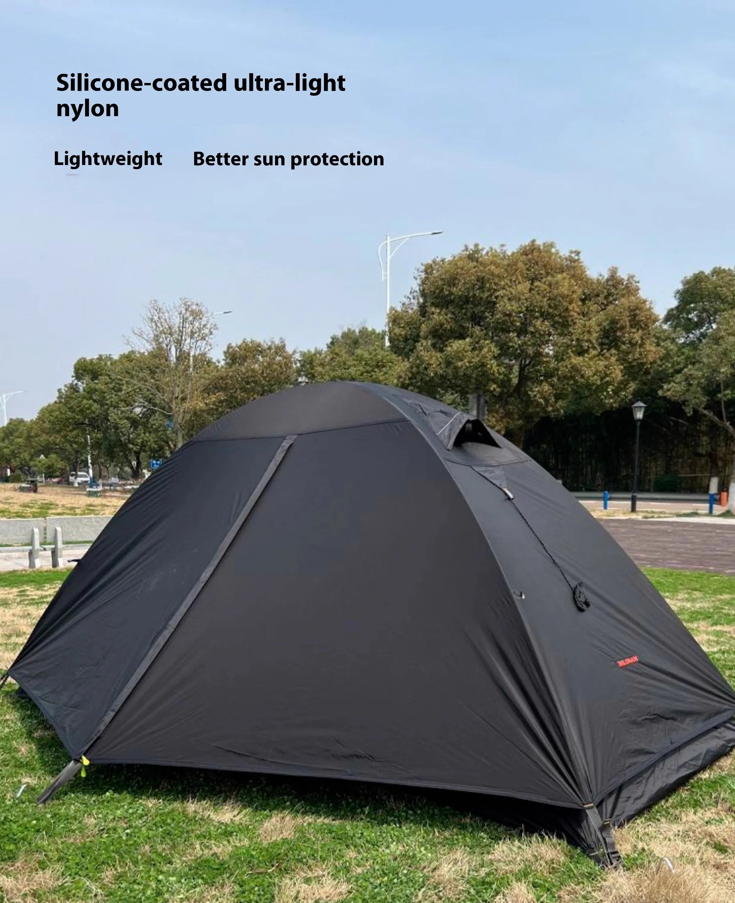Single person hiking tent with aluminium poles pitched in outdoor setting showing red colour option
