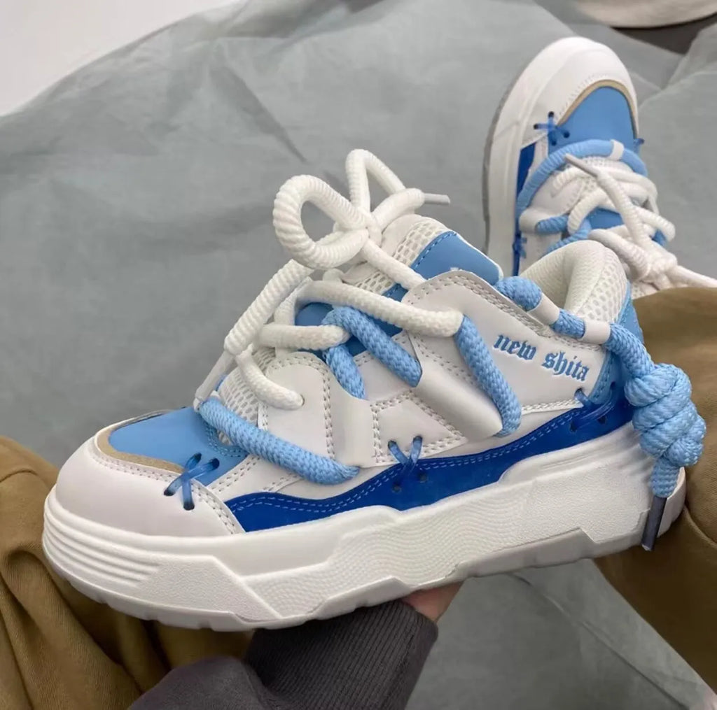 Women's grey retro clunky sneakers with thick rubber platform sole and lace-up front.