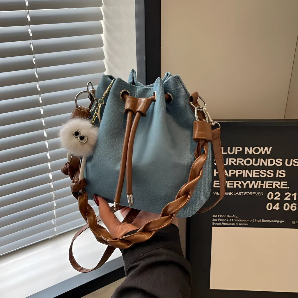 Blue synthetic leather cross-body bucket bag with sandwich pocket design