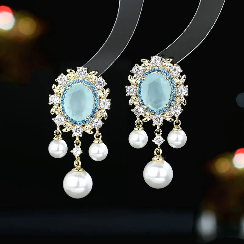 Copper oval earrings with zircon inlay and pearl tassels in light purple colour