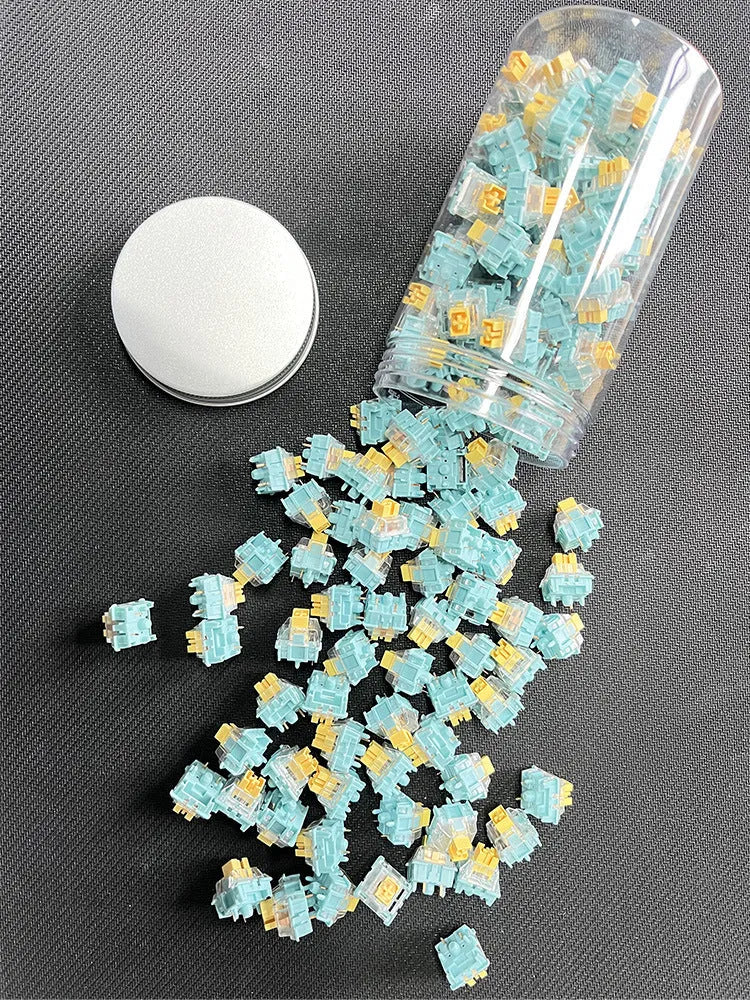 36 Sea Salt Lemon coloured PRO Mute mechanical keyboard switches laid out on a surface.