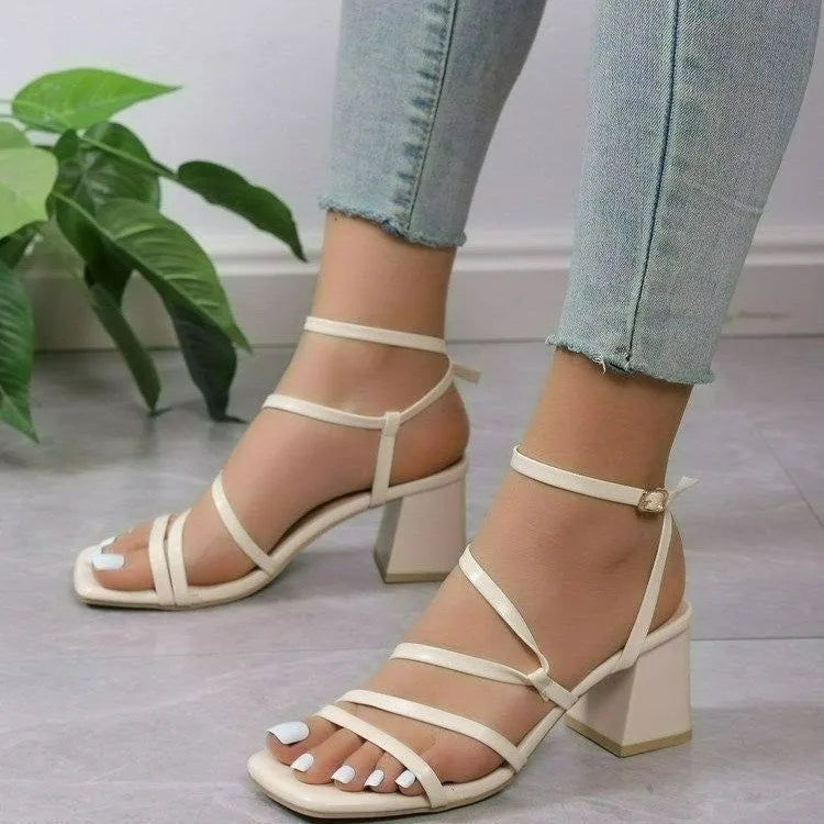 Plus size beige open toe slippers with square toe and ankle buckle on a rubber sole.