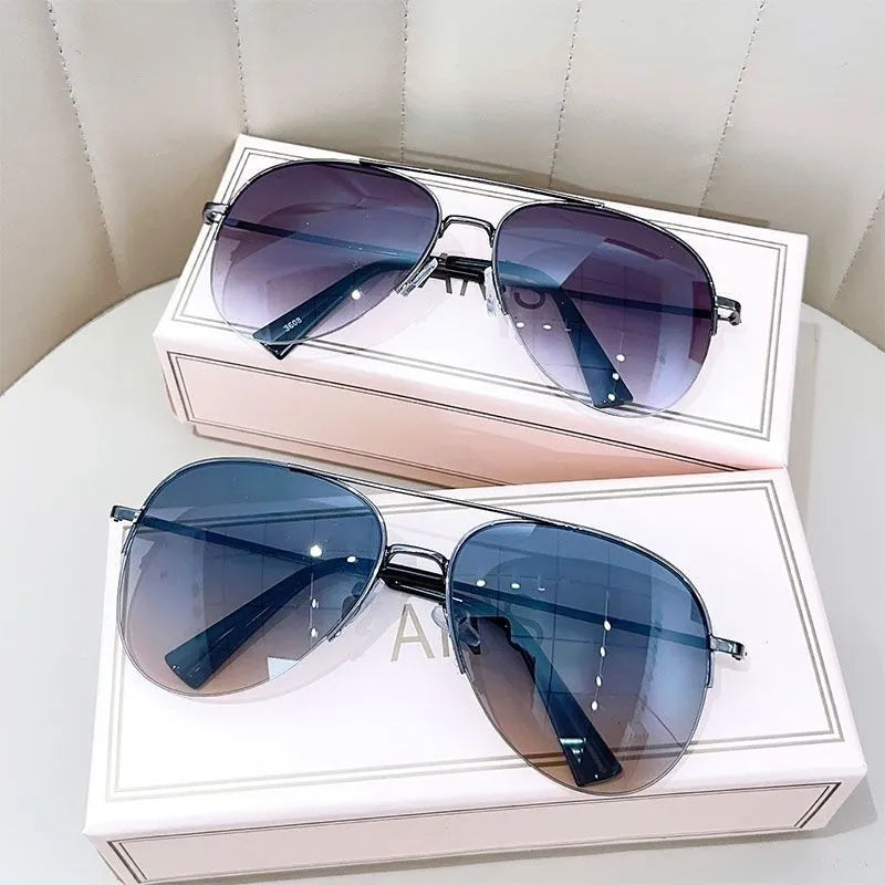 Gold frame aviator-style metal driving sunglasses with resin lenses for UV protection.