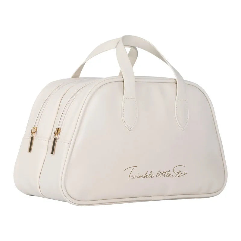 Leather travel toiletry bag open, showing interior compartments and dry-wet separation, in caramel mocha colour.