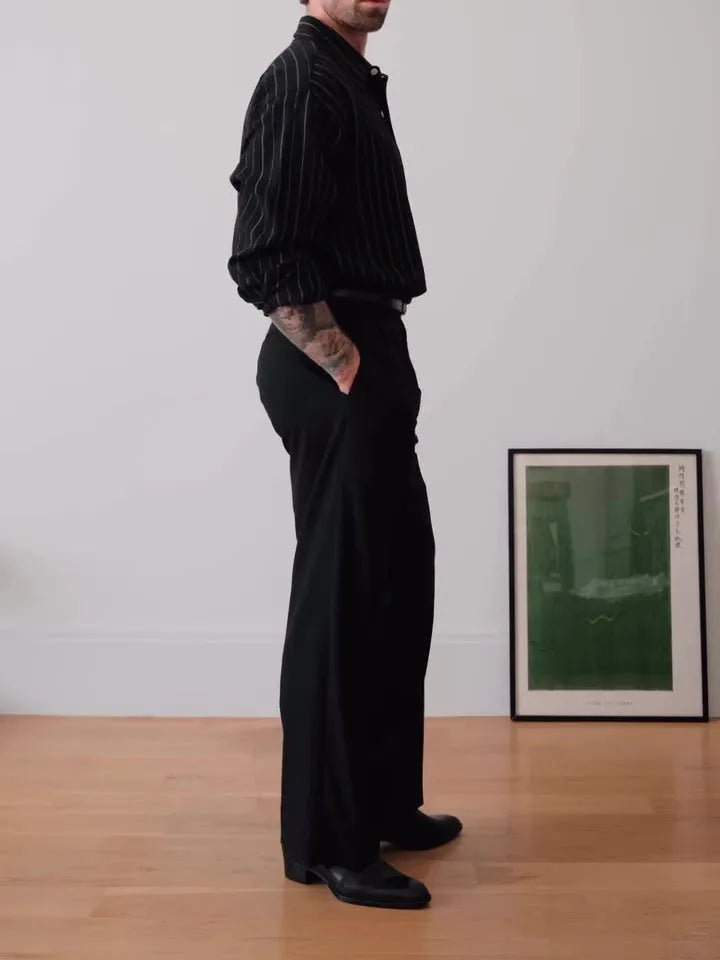 Black pinstripe button-down shirt on hanger showing striped pattern and button front