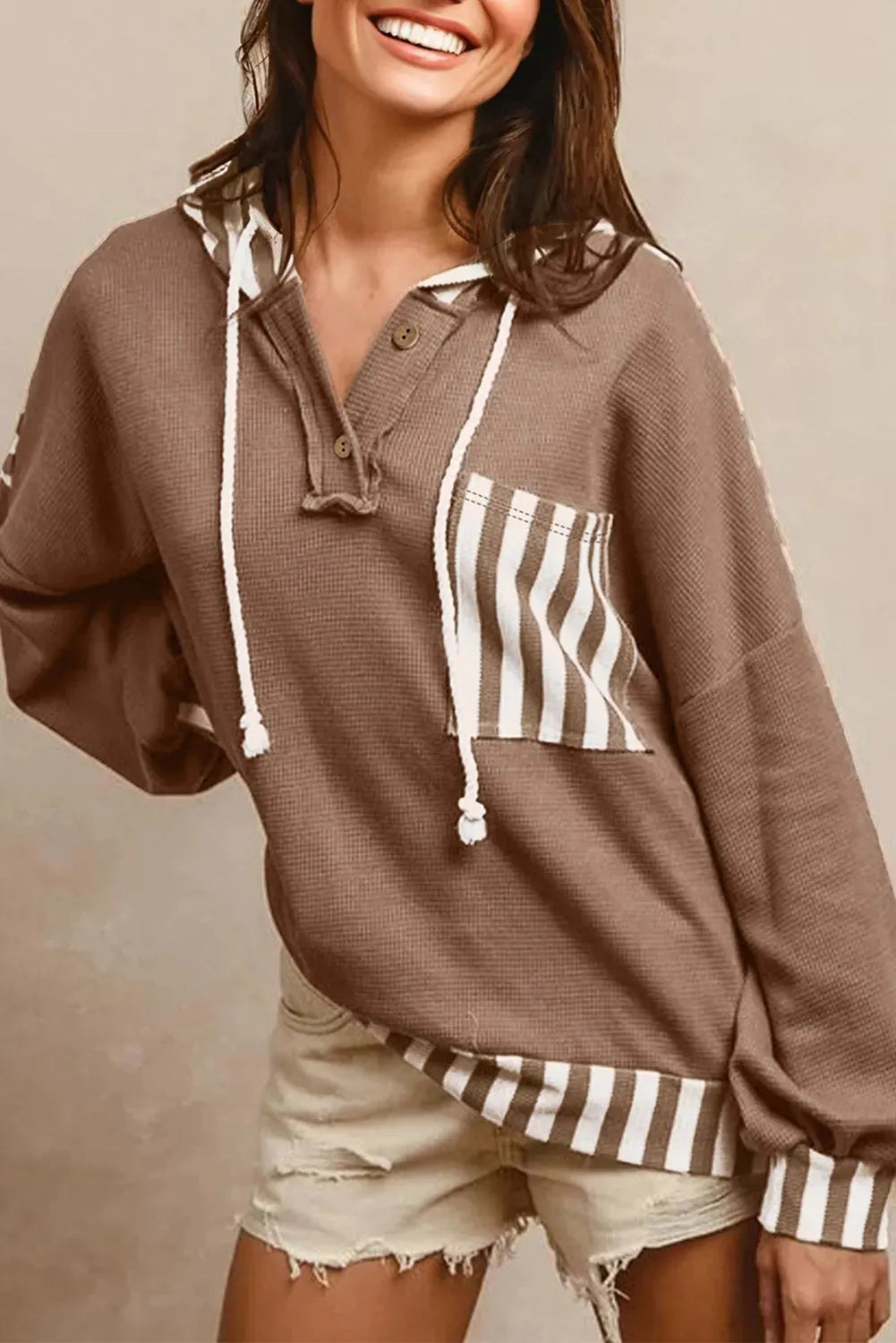 Straw yellow hoodie with waffle texture fabric and striped patchwork panels, button neck and drawstring waist