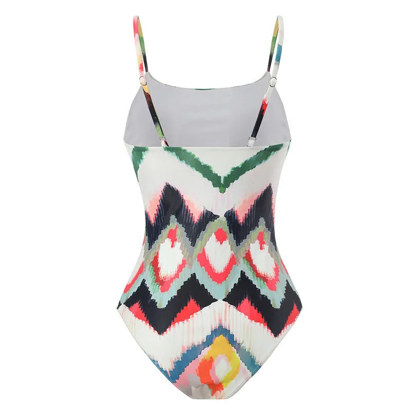 Women's two-piece striped swimsuit with a matching gradient print hip skirt laid flat.
