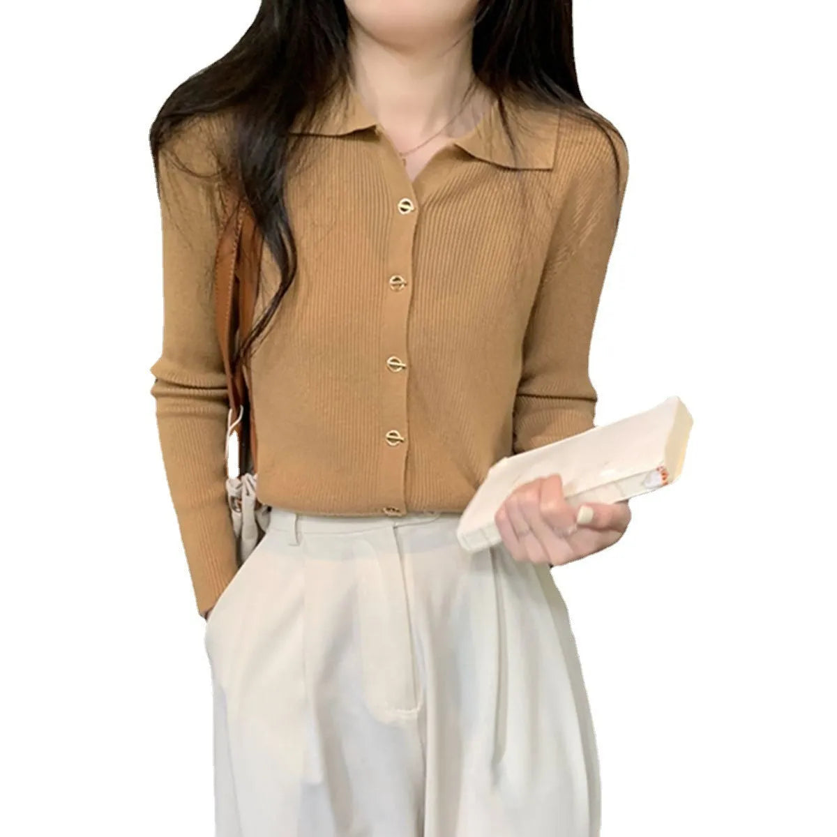 Loose fit beige viscose knitted cardigan top with long sleeves on a hanger