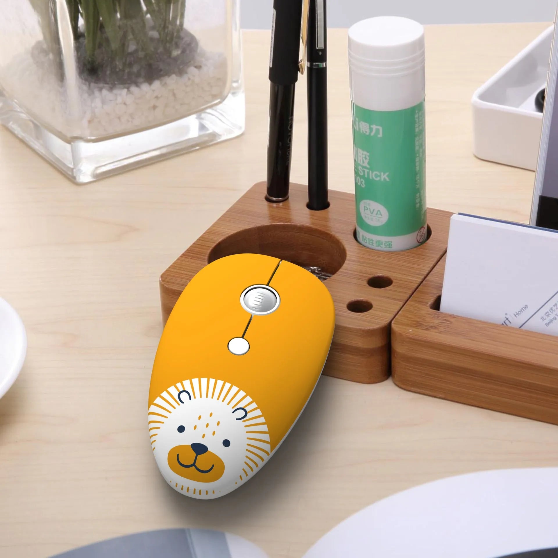 Compact wireless optical mouse with cartoon animal design next to USB receiver for laptop computers