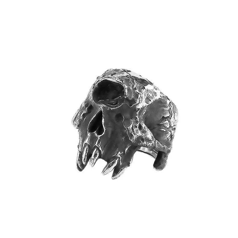 Silver-toned alloy ring with a detailed one-eyed skull design on a black background.