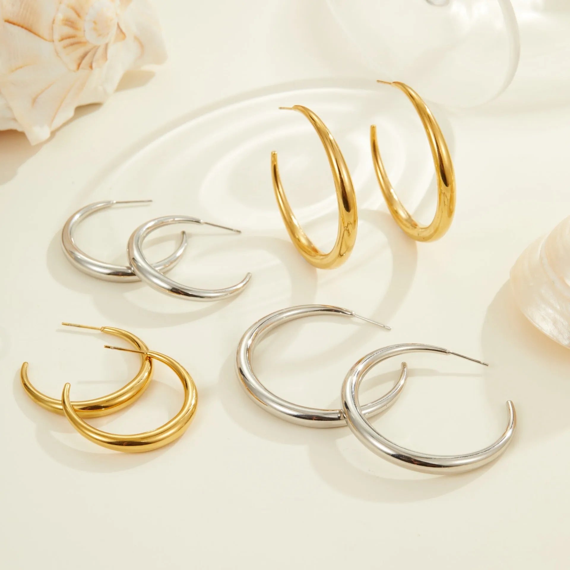 Simple geometric round hoop earrings in gold and steel finish made of stainless steel with 18K PVD plating