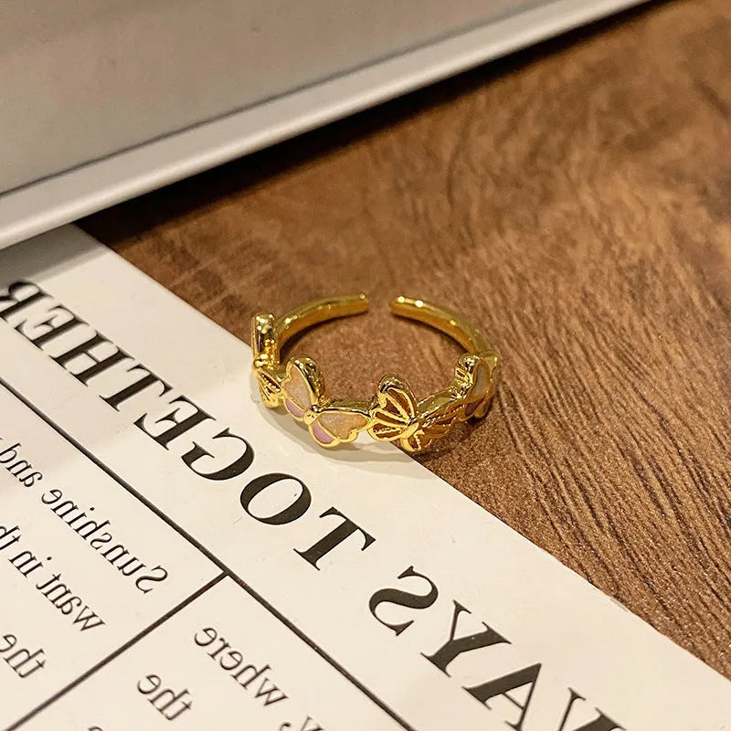 Copper butterfly women's ring with drip oil finish in an open-loop design.