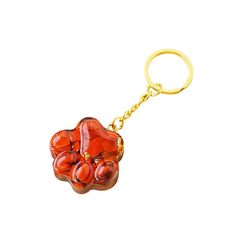 Small handcrafted crystal cat's paw shaped keychain pendant on a keyring.