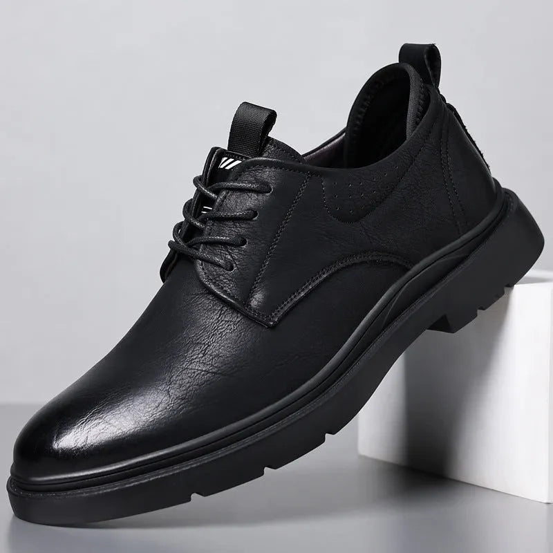 Men's black leather casual sneakers with sewing line detailing and rubber soles