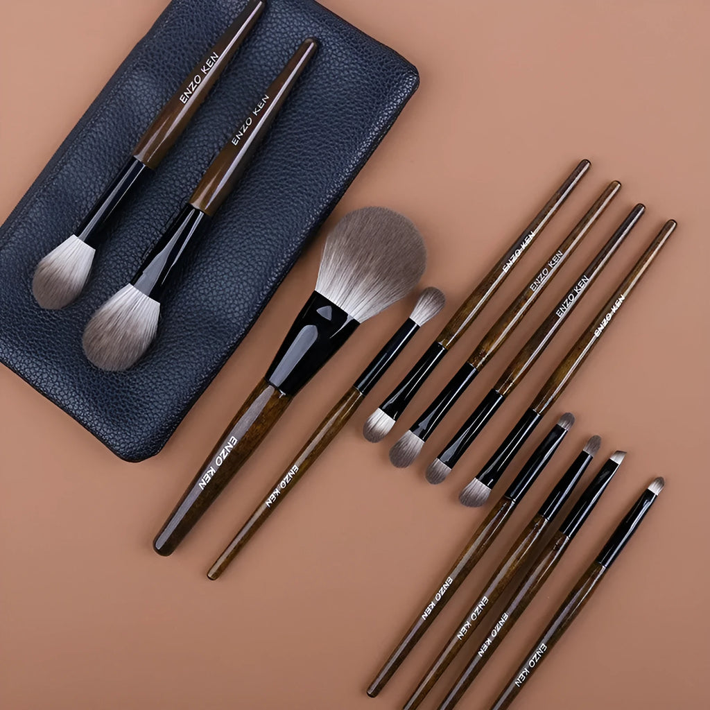 12 makeup brushes with wooden handles stored in a black PU roll, showing the powder foundation brush.