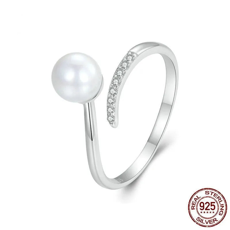Adjustable S925 sterling silver ring with natural shell pearl elements and open loop design