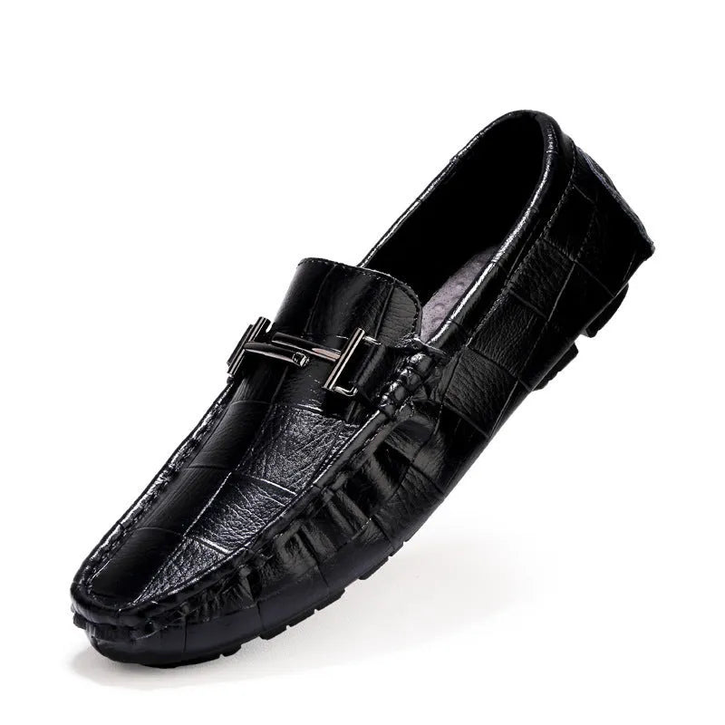 Men's black casual leather peas shoes with a belt buckle detail and flat rubber sole on a white background