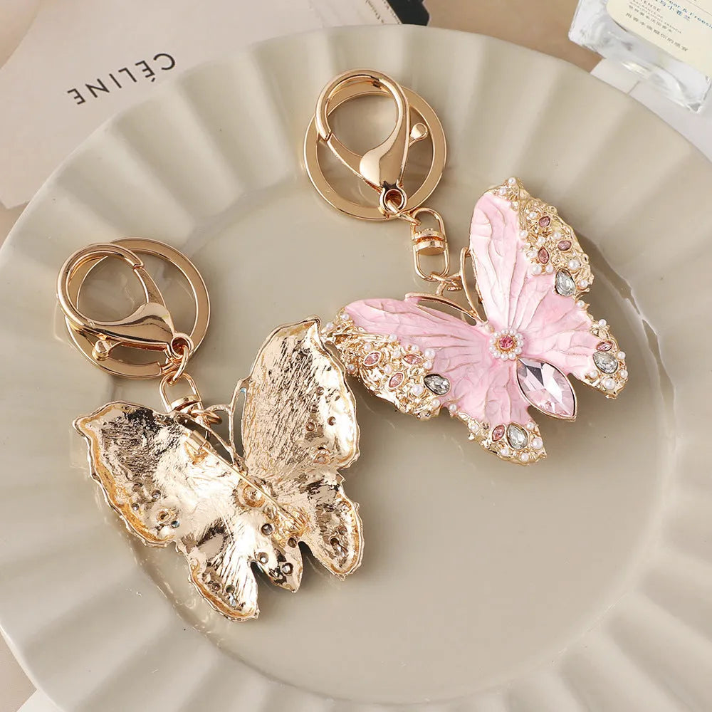 Enamel dripping oil butterfly brooch keychain in pink or blue, dual purpose European style metal accessory.