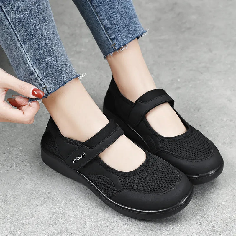 Women's low-top casual sneaker in grey mesh with velcro strap and flat polyurethane sole.
