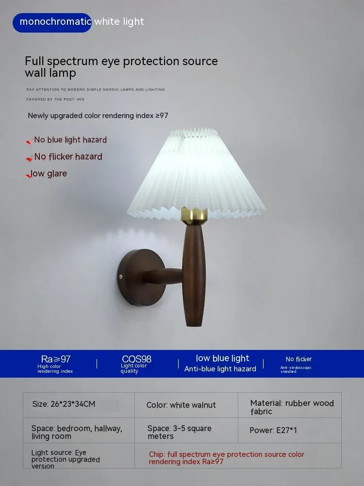 American Retro style wooden wall lamp with copper accents and a white fabric shade mounted above a bedside table.