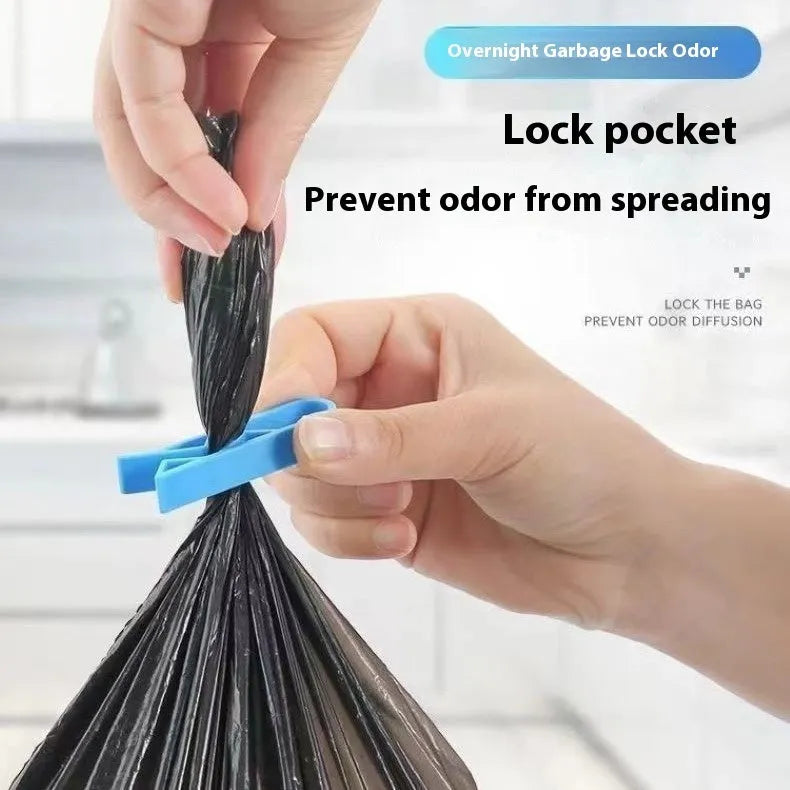 White PP plastic garbage bag fixing clip shown holding a black bin liner to the rim of a silver trash can.