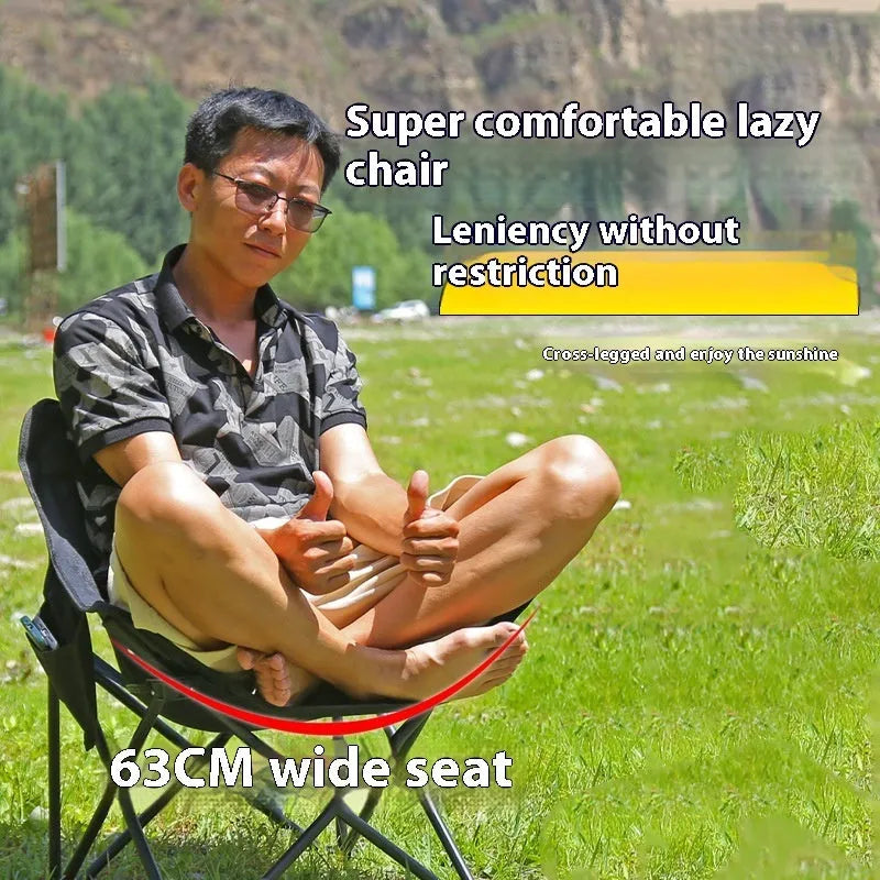 Beige folding camping chair with reclined back and steel frame on grass.