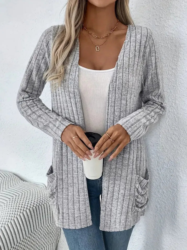 Loose fit grey cardigan with long sleeves and side pockets on a hanger.