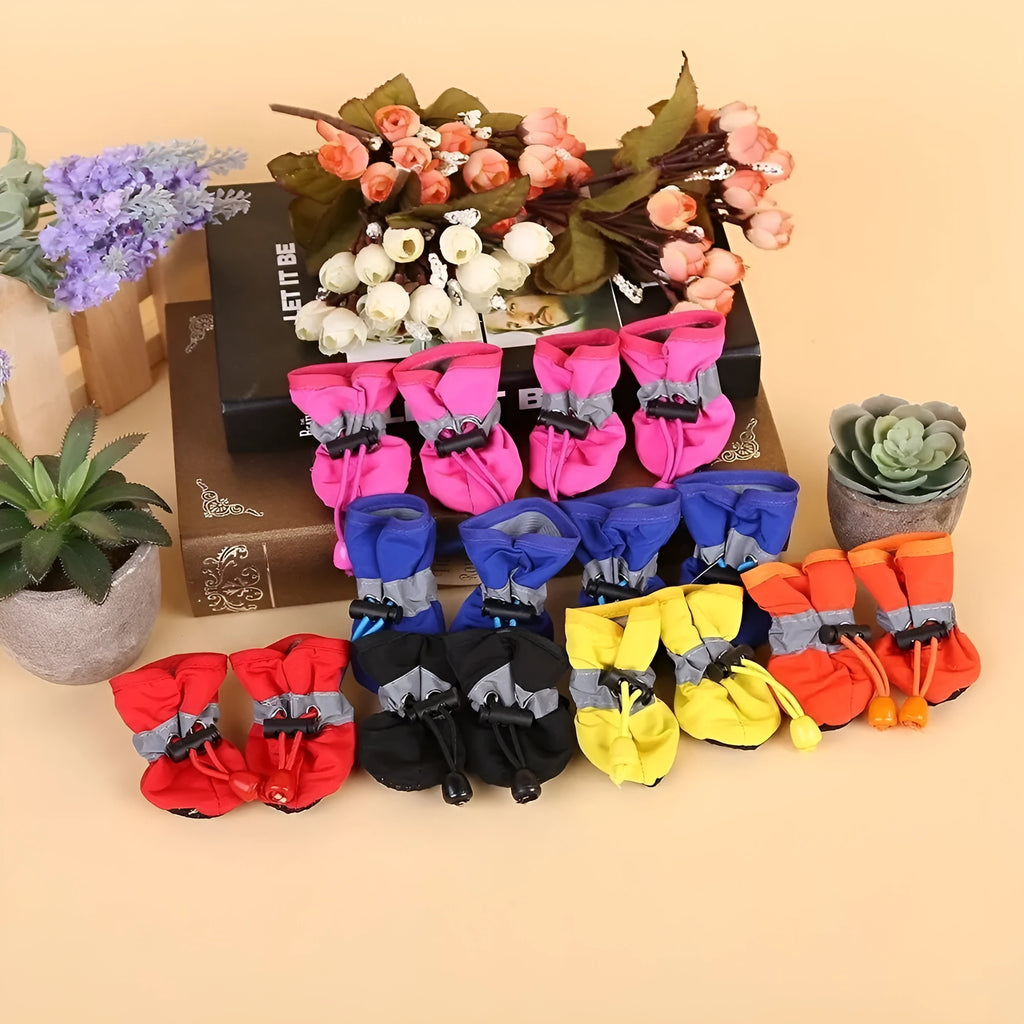 Set of four cloth dog shoes in various colours including fleece-lined red and monkey patterns