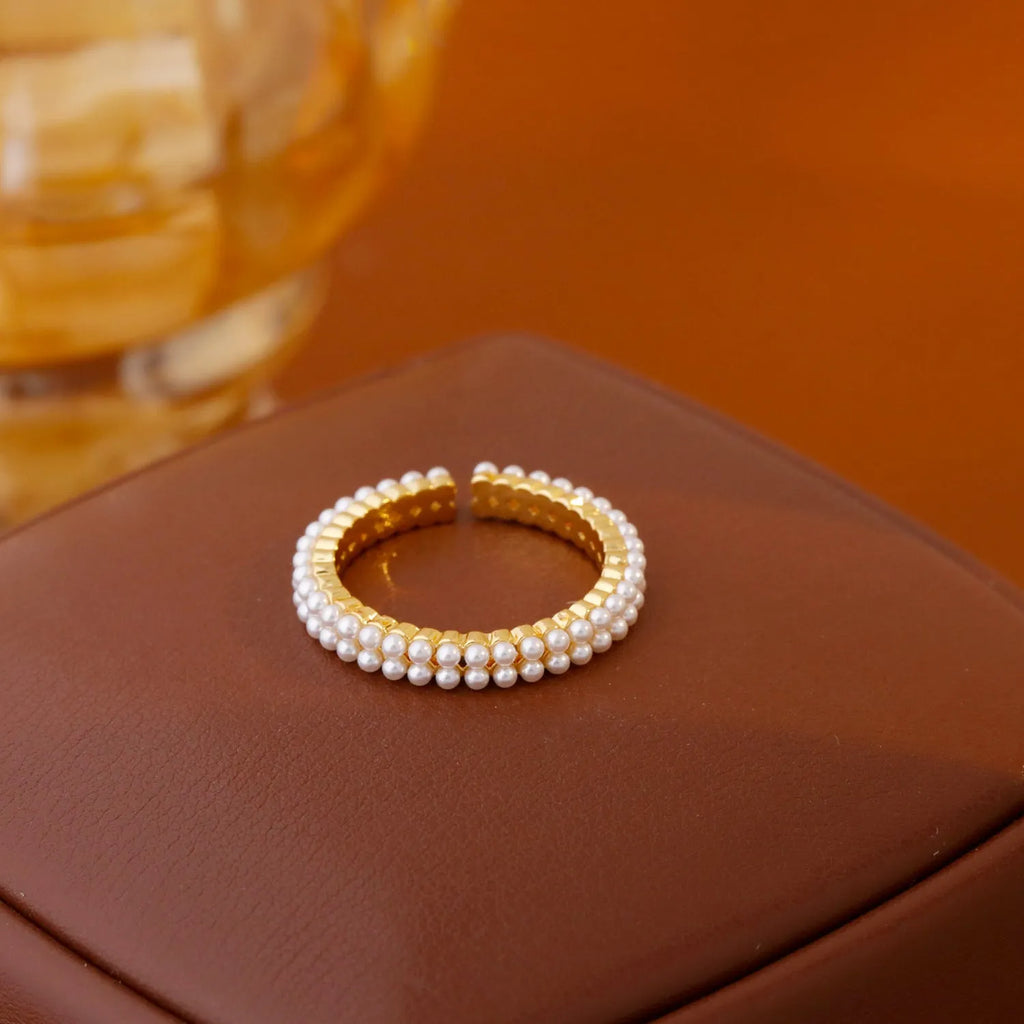 Gold geometric open mouth women's ring with central pearl on copper with electroplated finish