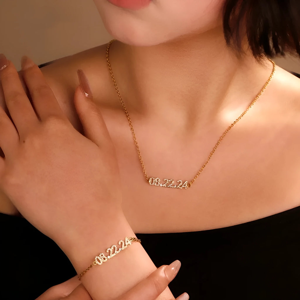 Stainless steel digital bracelet or necklace with diamond-set numbers in gold, rose gold, or steel colour.