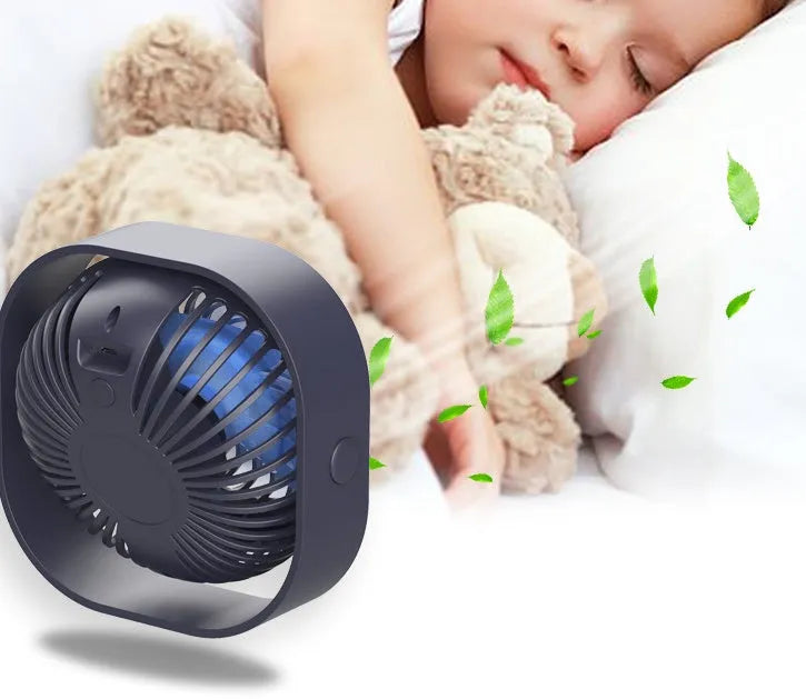 USB-powered desktop fan with alarm clock style in blue, pink, green, or white, showing 360-degree rotation.
