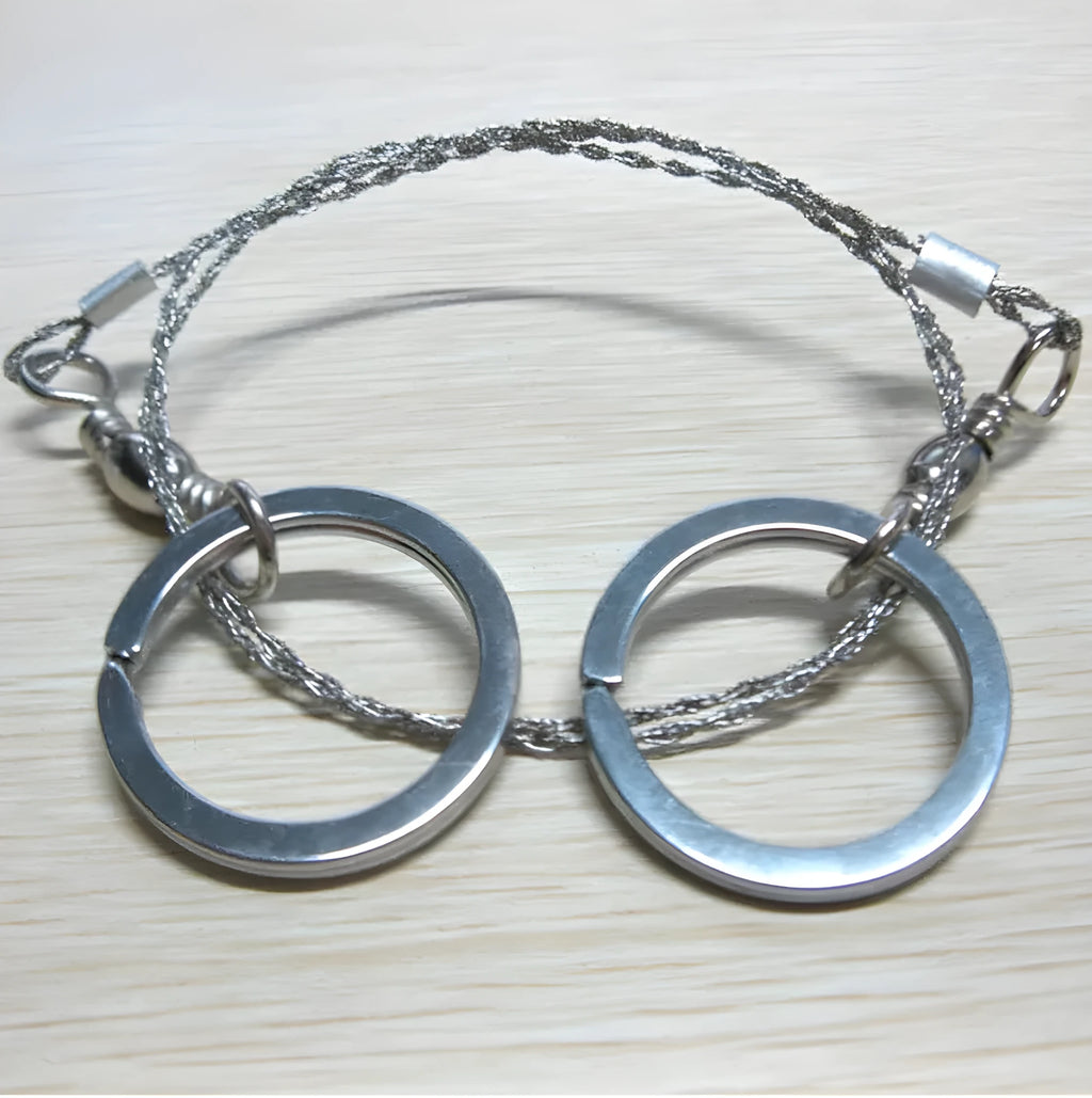 Stainless steel survival wire saw with thumb rings showing 55cm blade and pull ring assembly