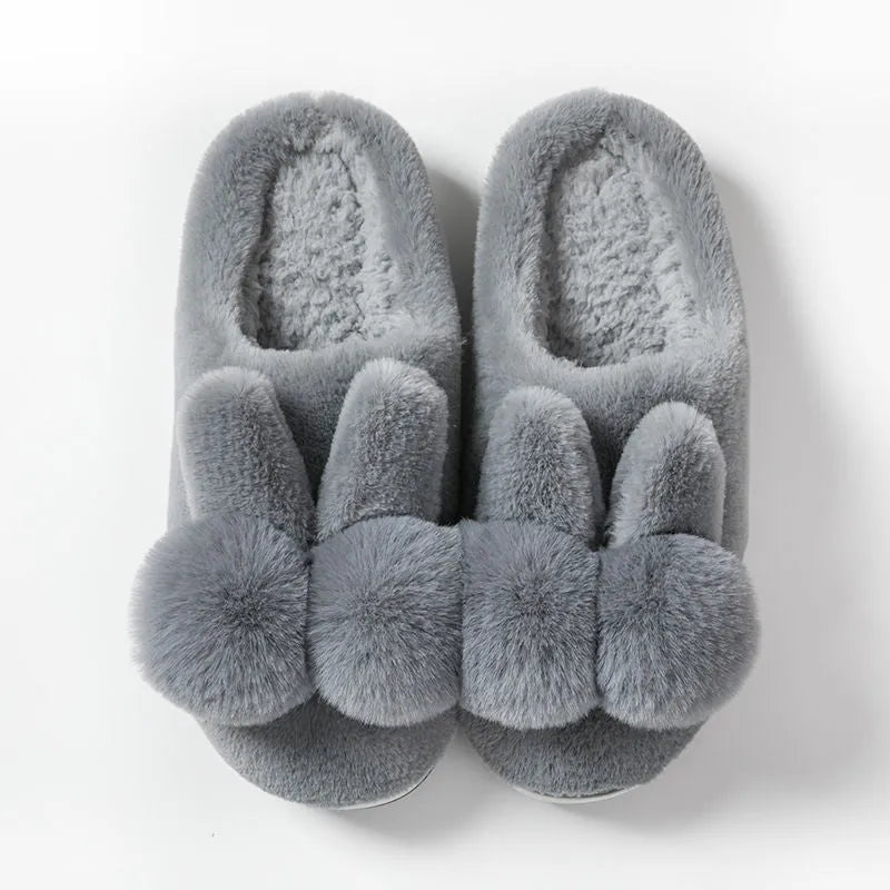 Women's fluffy bunny slippers in creamy white with a high rabbit fur upper and decorative flowers.