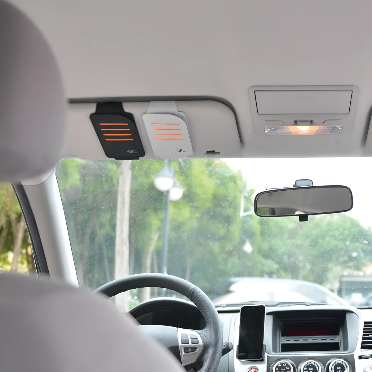 Car sun visor shading panel set showing four foldable tablets and a vehicle-mounted storage bag in grey or black.