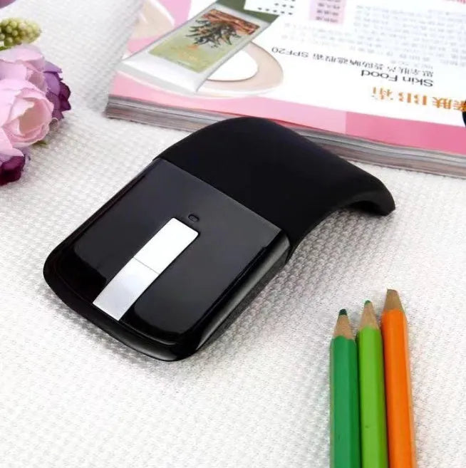 Black folding Bluetooth wireless mouse showing touch scroll area and compact folded size