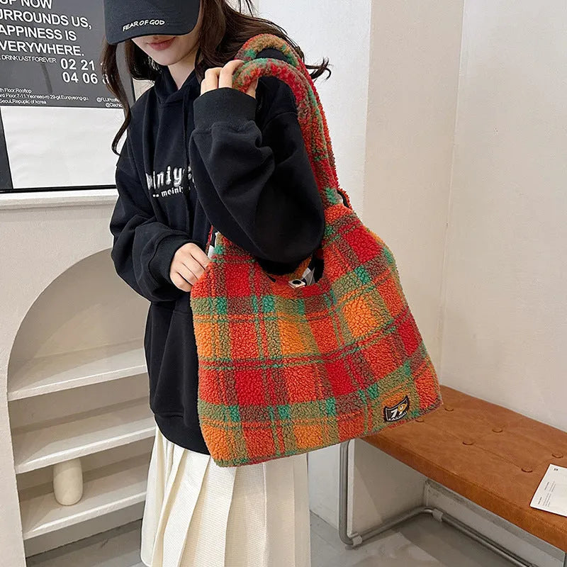 Women's plaid crossbody tote bag in soft plush material with shoulder strap and zippered compartment